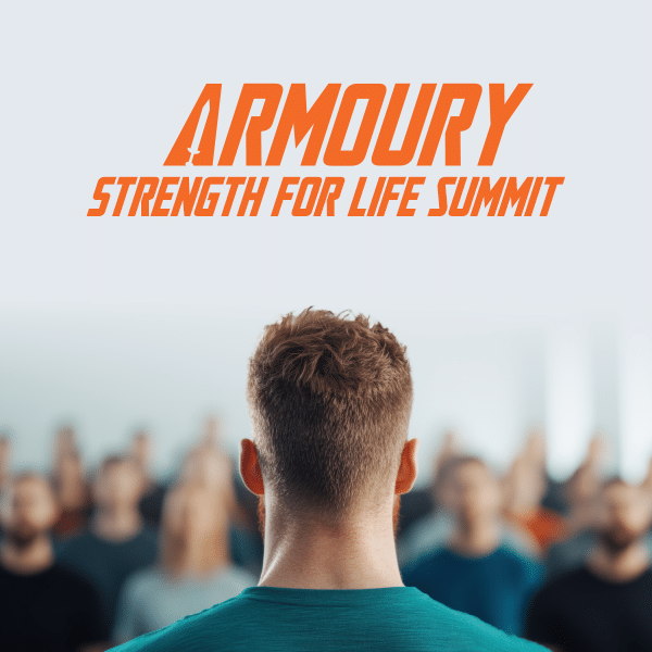Focus on the back of a man's head while he looks to a blurred seminar crowd with Armoury Logo